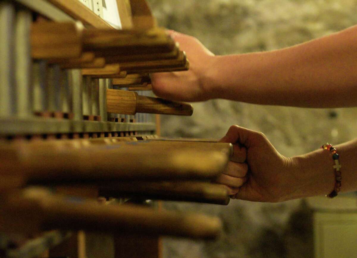 Tatiana Lukyanova practices on the carillon keyboard in St. James Episcopal Church steeple before the churches first Summer Carillon Concerts on Wednesday, June 29, 2022. Lukyanova, of New Britain, is the organist and accompanist at the South United Methodist Church, in Manchester, carillonneur at the First Church of Christ Congregational in New Britain, and a carillonneur-in-residence at Storrs Congregational church. Danbury, Conn.