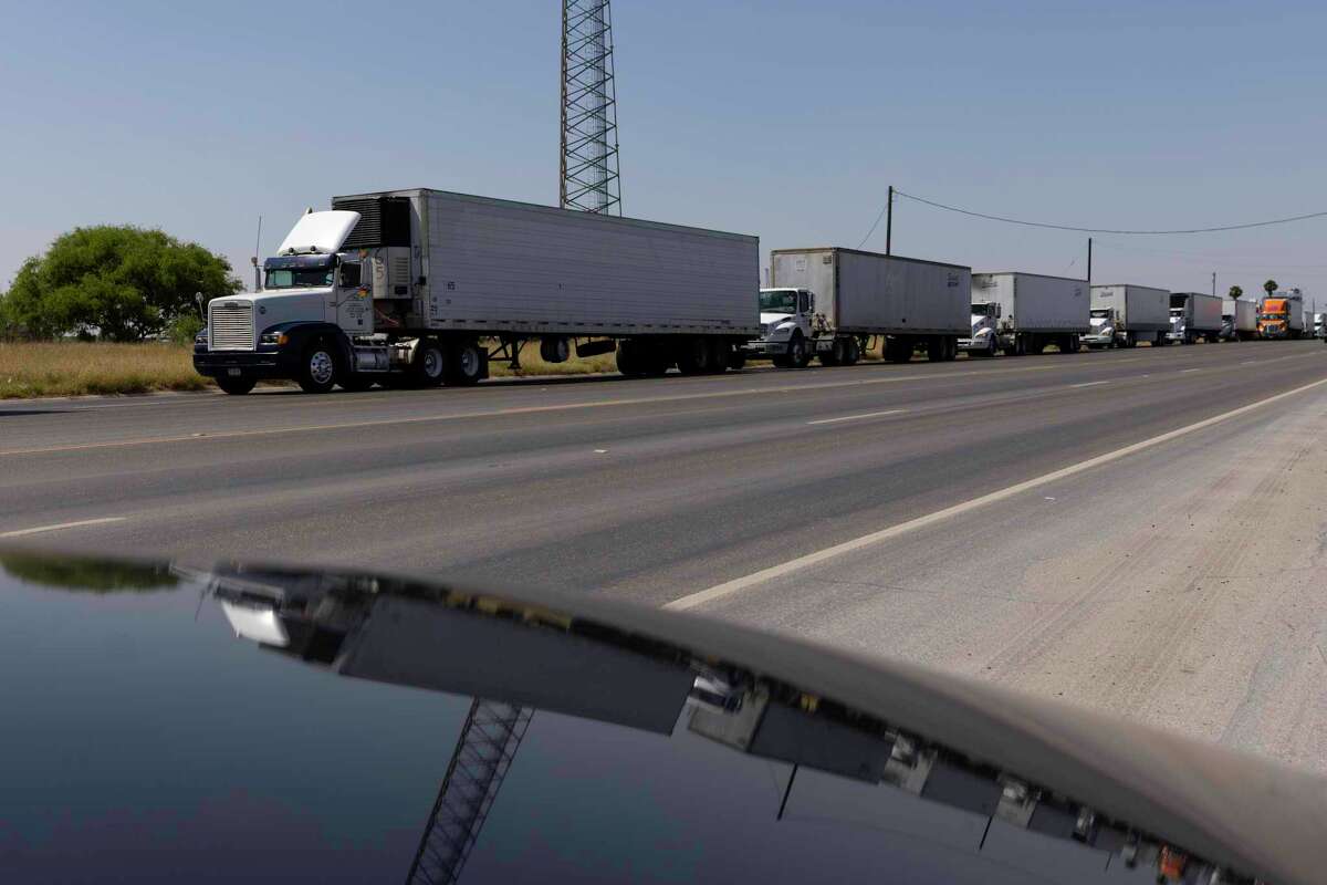 PROGRESO, TX - APRIL 13: Hundreds of commercial trucks wait in line to cross the Progreso International bridge into Mexico on April 13, 2022 in Progreso, Texas. The bridge reopened to commercial traffic after 5 p.m. after being closed since Monday because of Mexican truckers on strike. (Photo by Michael Gonzalez/Getty Images)