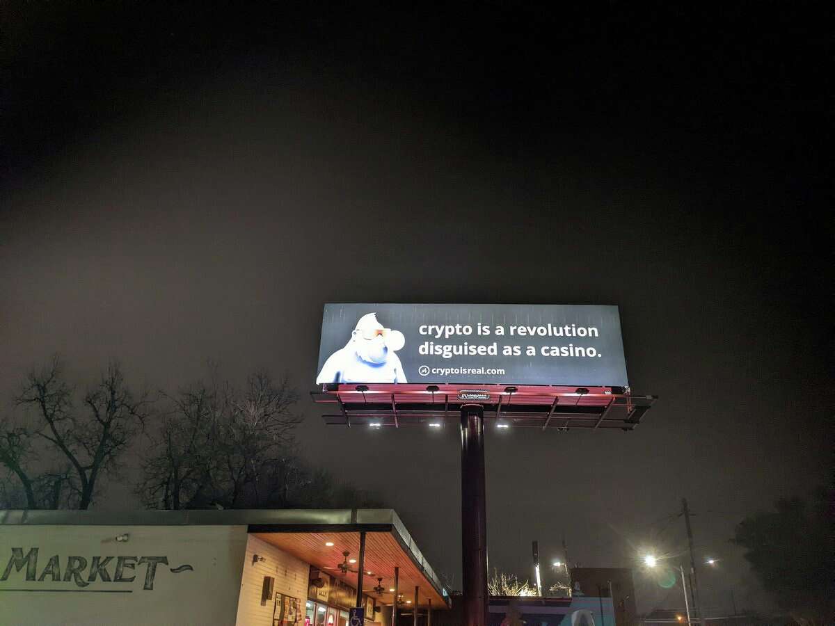 A now-gone crypto billboard next to a Thom's Market location in Austin.