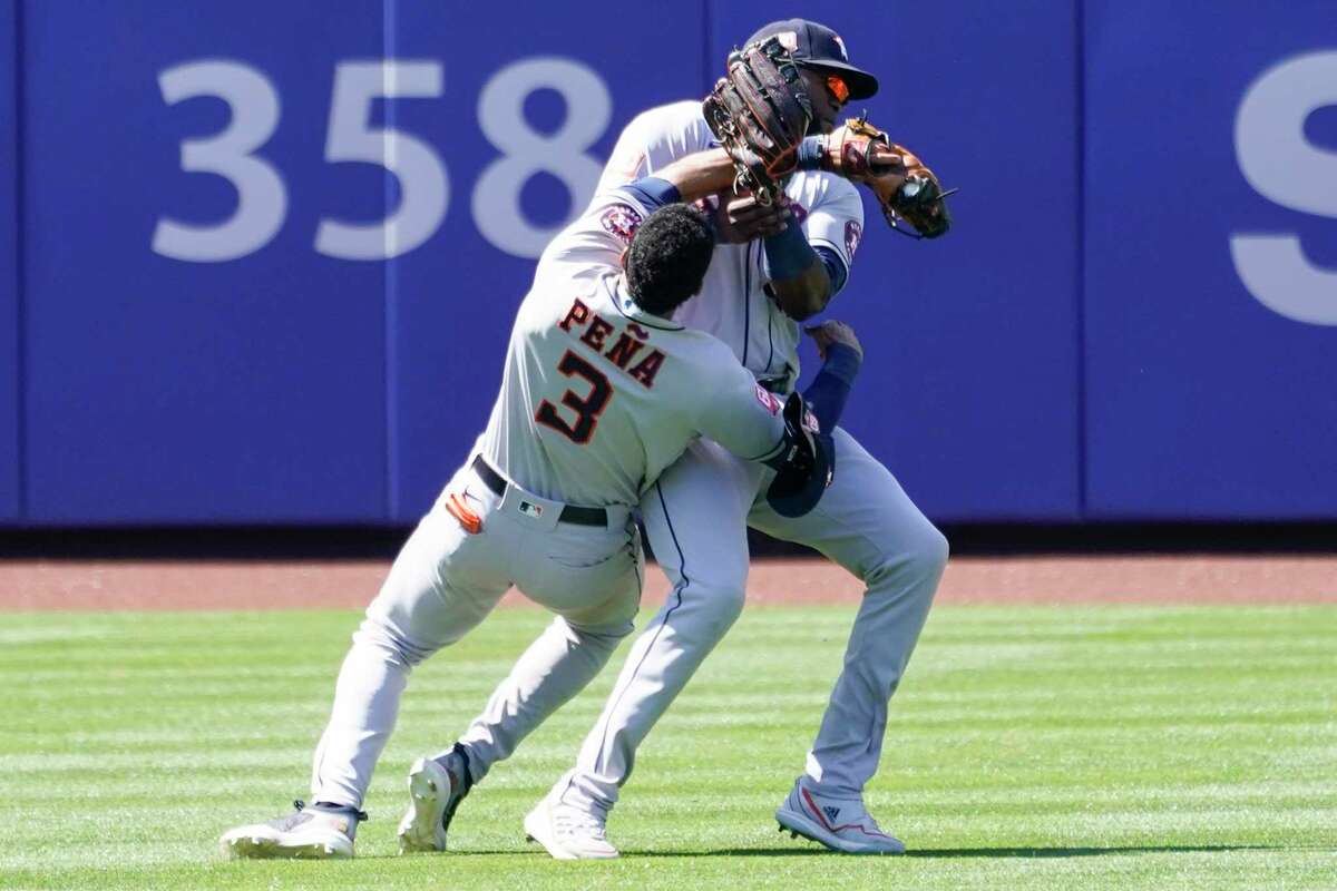 Houston Astros' Jeremy Pena (3) and Yordan Alvarez collide catching a fly ball by New York Mets' Dominic Smith during the eighth inning of a baseball game, Wednesday, June 29, 2022, in New York. (AP Photo/Mary Altaffer)