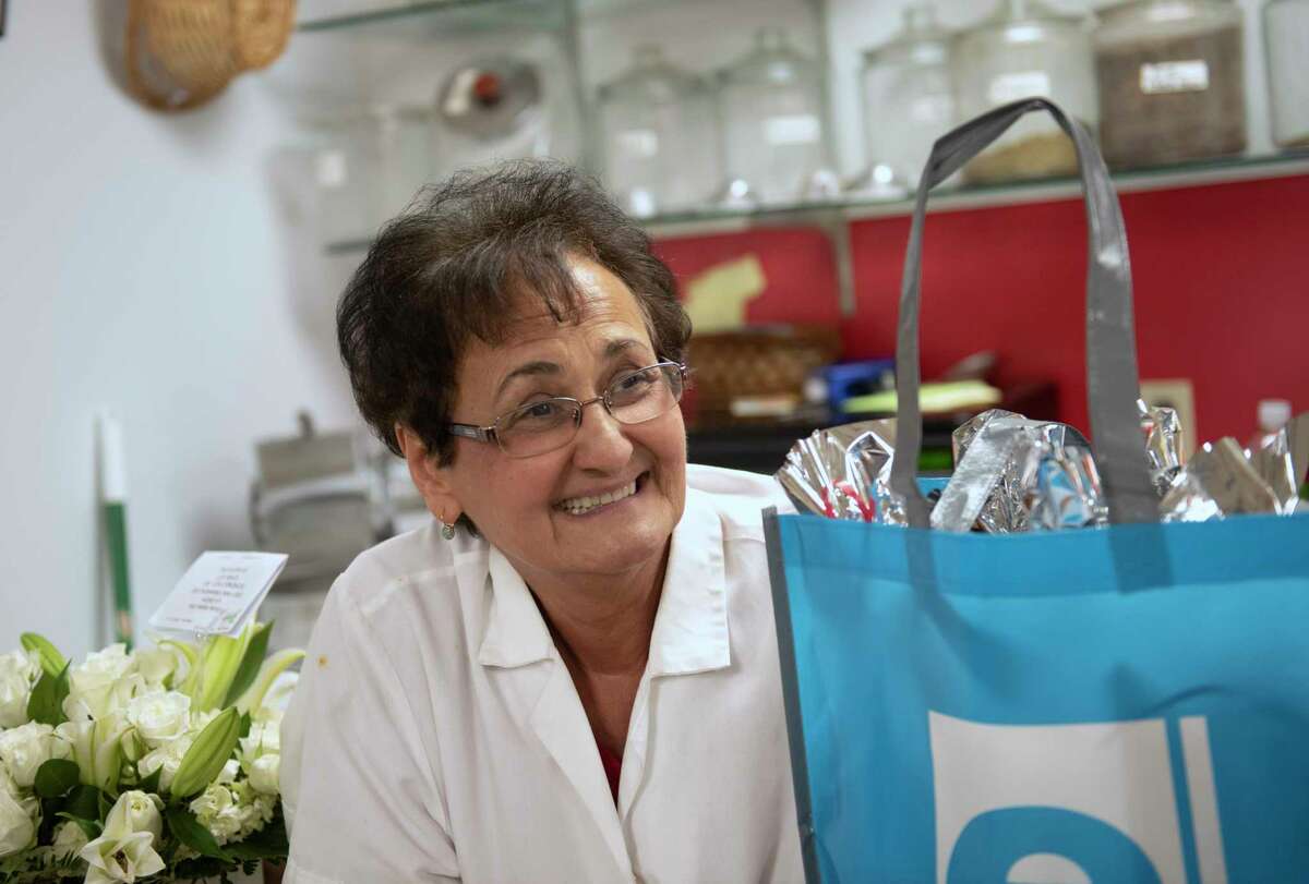 Co-owner Anna DiCocco is seen among gifts from customers in La Gioia Italian Deli on Wednesday, June 22, 2022 in Schenectady, N.Y. The deli is closing after 33 years.