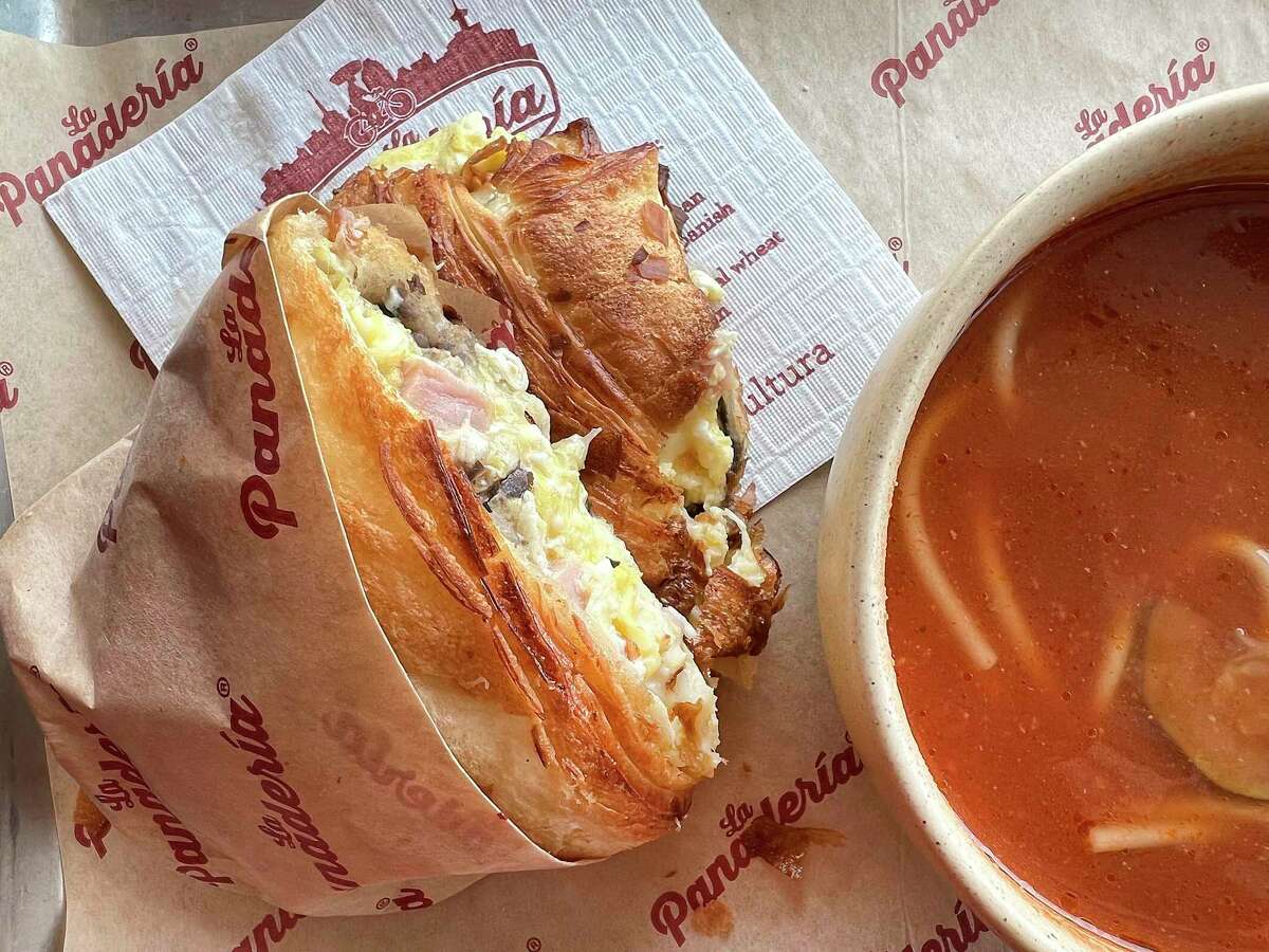 A ham, cheese and egg torta includes scrambled eggs, ham, melted cheese and black bean spread at La Panadería, a Mexican-style bakery on Broadway. Bread choices include a house-baked croissant, shown here, with fideo soup on the side as part of the bakery’s build-your-own torta menu.