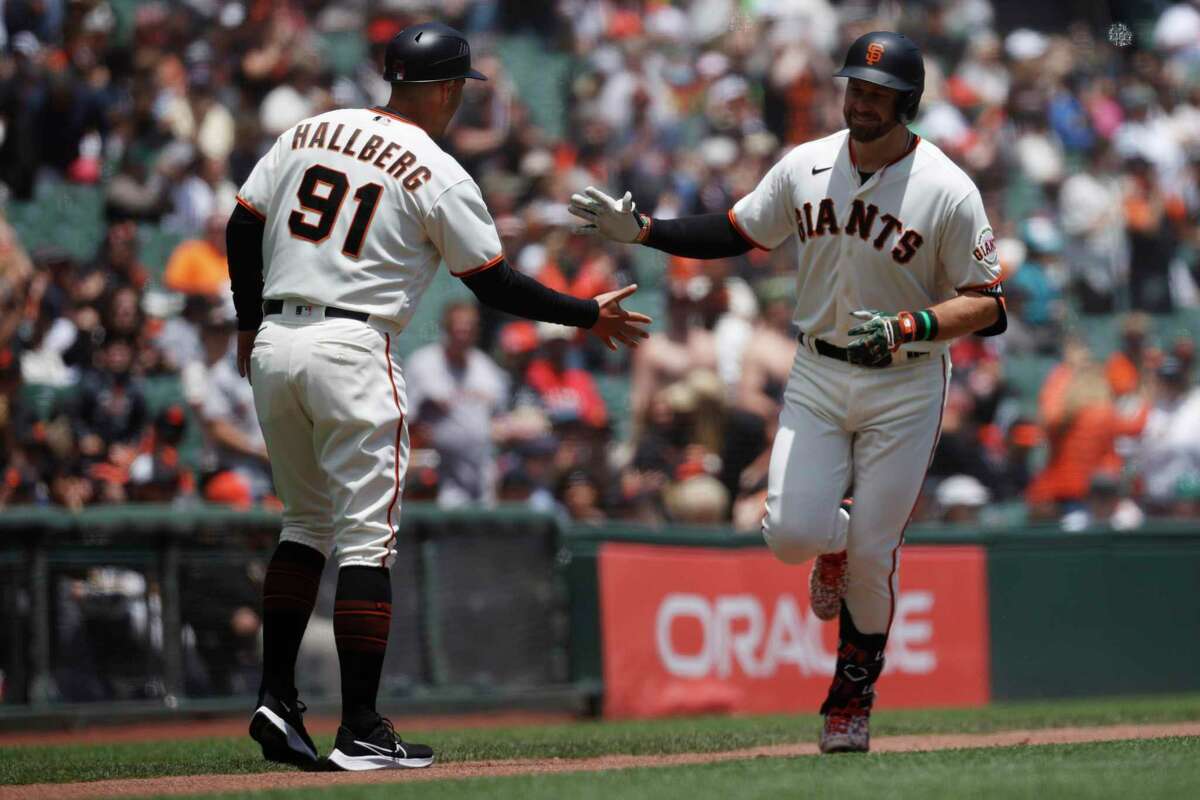 San Francisco Giants’ Evan Longoria is being congratulated by Third Base Coach Mark Hallberg after hitting a solo home run during the first inning of a MLB baseball game against Detroit Tigers in San Francisco, Calif. Wednesday, June 29, 2022.