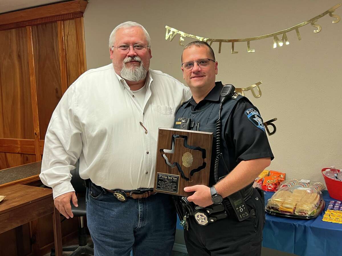 Kountze Police Chief Brent Slaughter and Captain David Nunn stand with Nunn's award on June 29.