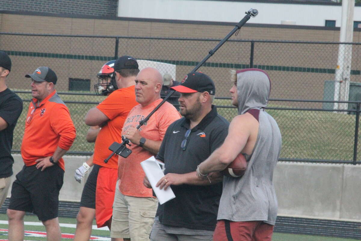 Former Reed City football coach Monty Price (second from right) watches his Belding team during a 7-on-7 scrimmage at Big Rapids on Thursday.