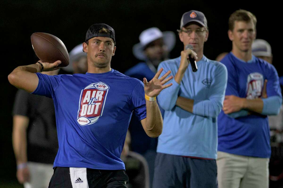 University of Houston quarterback Clayton Tune, left, airs it out next to Cooper Manning, center, and former NFL quarterback Eli Manning, right, at the Manning Passing Academy on the Nicholls State University campus in Thibodaux, La.