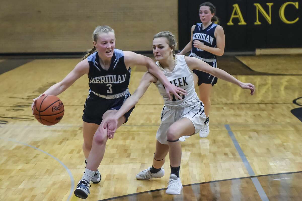 Meridian's Halen McLaughlin drives into the lane during a Dec. 22, 2021 game against Bullock Creek. McLaughlin scored 30 points Tuesday in the Mustangs' season-opening win over Evart.