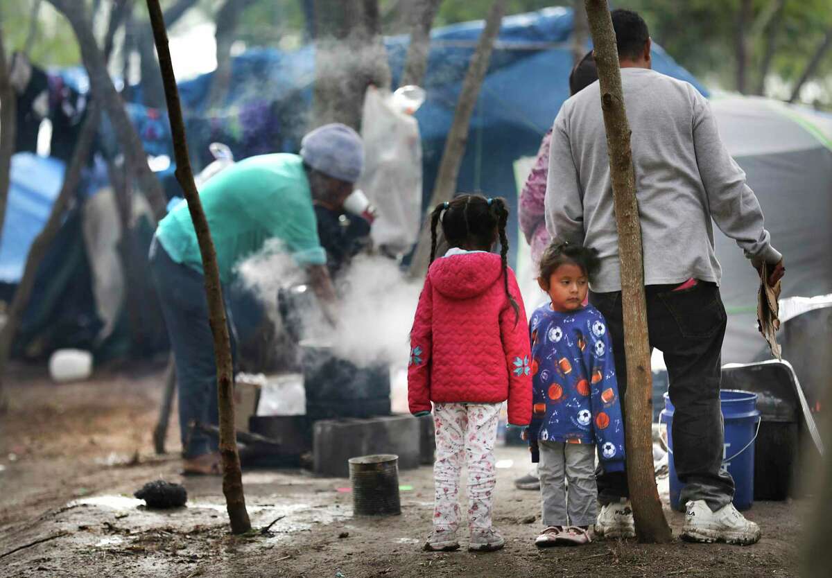 A family, pictured Nov. 13, 2019, cooks a meal at their tent at a refugee camp in Matamoros, Mexico, where thousands of asylum seekers were sent to await immigration proceedings under the Trump-era “Remain in Mexico” program.