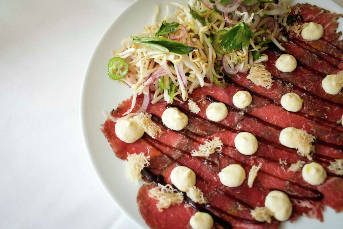 Pho-cured beef tenderloin carpaccio at the new Georgia James steakhouse.