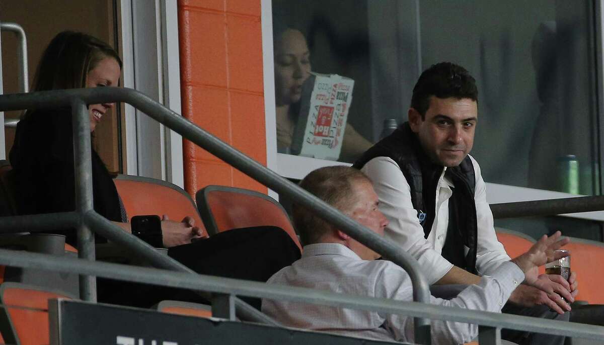 Perched in a suite at PNC Stadium, Houston Dynamo FC and Dash majority owner Ted Segal, right, watches an NWSL match in March with president of business operations John Walker, center, and Dash president Jessica O'Neill.