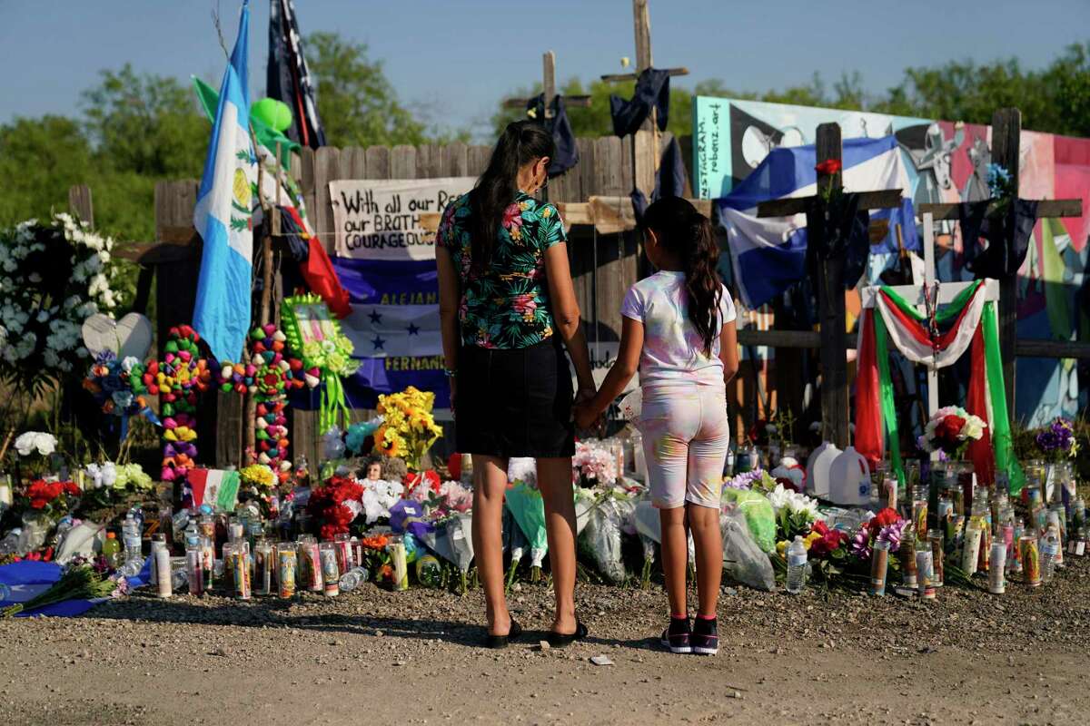 Mourners visit a make-shift memorial at the site where dozens of suspected migrants died in an abandoned tractor-trailer Thursday, June 30, 2022, in San Antonio. (AP Photo/Eric Gay)