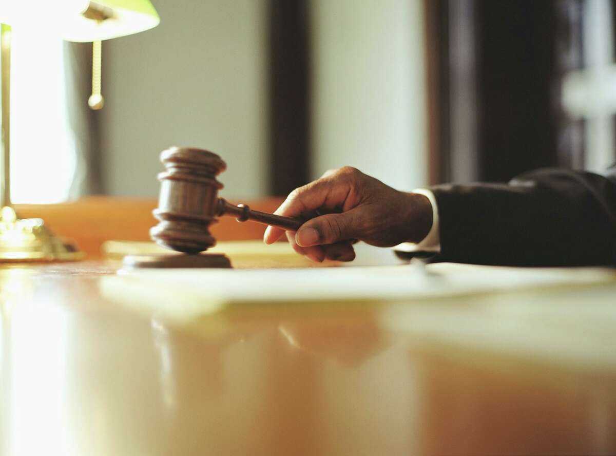 This file photograph shows a judge striking a gavel in a courtroom.