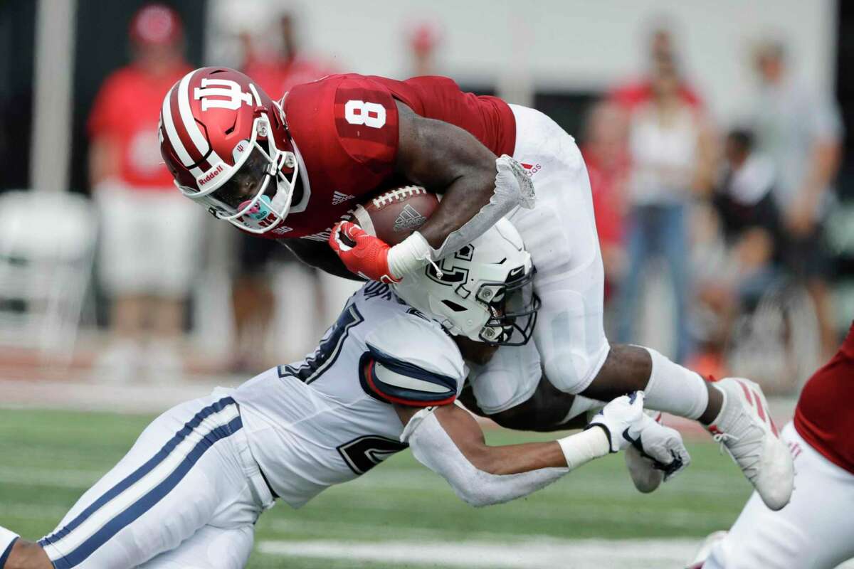 Indiana running back Stevie Scott III (8) is tackled by Connecticut linebacker Omar Fortt (27) during the first half of an NCAA college football game, Saturday, Sept. 21, 2019, in Bloomington, Ind. (AP Photo/Darron Cummings)