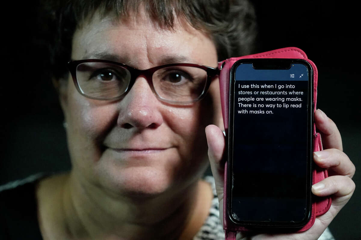 Chelle Wyatt uses her cellphone with the Otter app. People with hearing loss have adopted technology to navigate the world, especially as hearing aids are expensive and inaccessible to many.