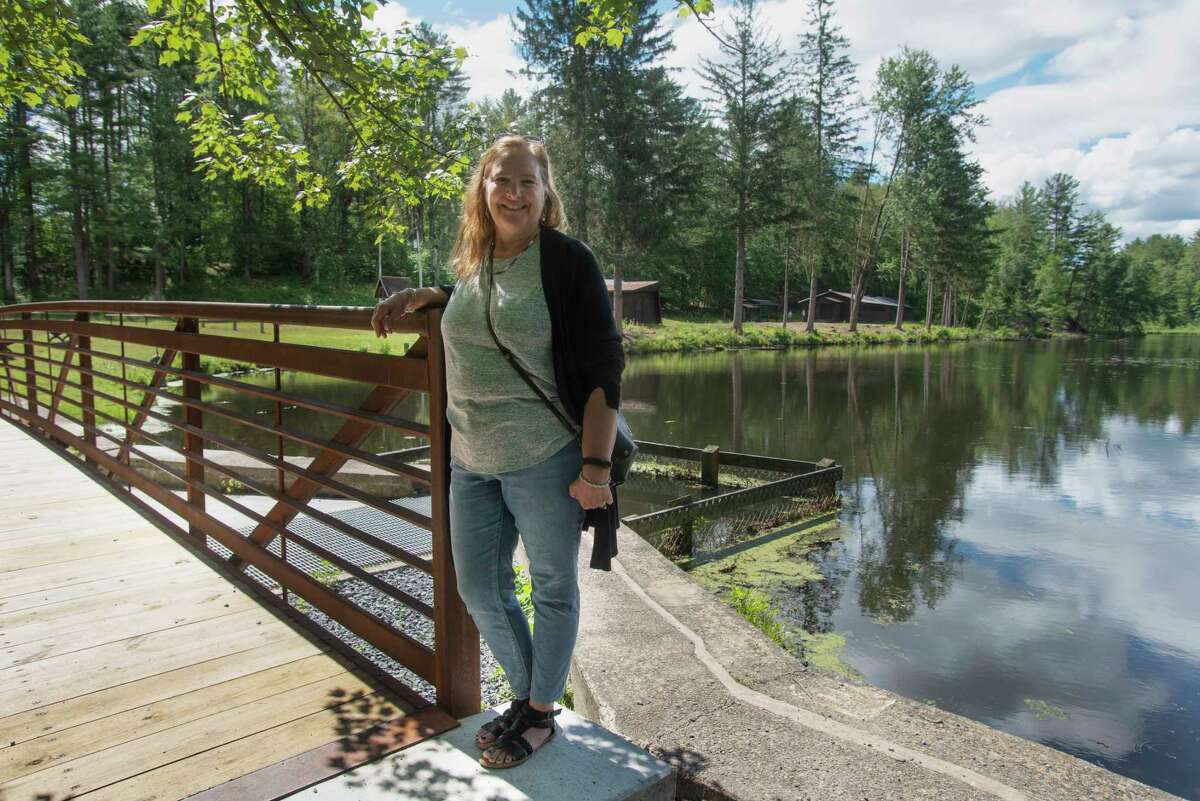 Margo Olson, the executive director of the Wilton Wildlife Preserve and Park, poses for a photo by Delegan Pond at the preserve on Tuesday, June 28, 2022, in Wilton, N.Y. (Paul Buckowski/Times Union)