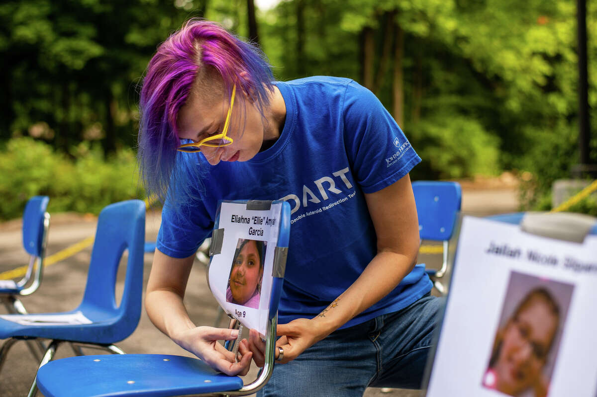 Maryland resident Brooke Tropf helps put together an anti-gun violence display on June 30, 2022 outside the United Church of Christ in Midland.