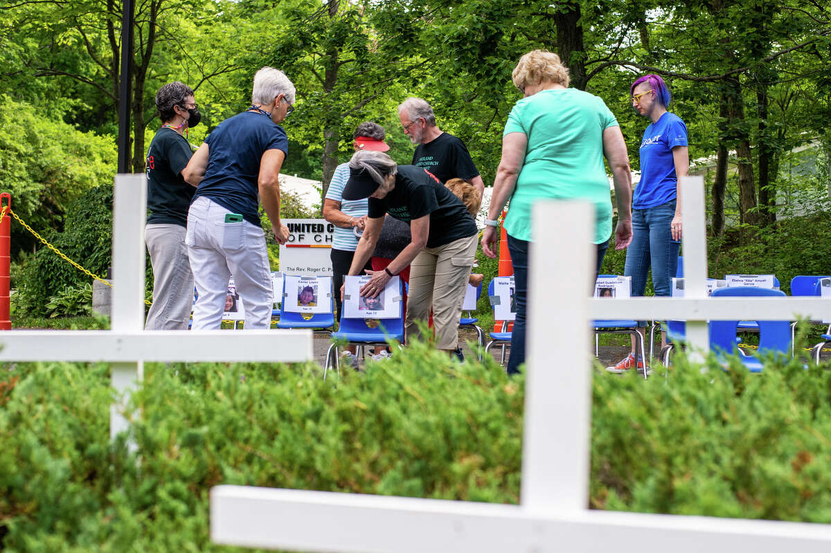 Church goers work to put together an anti-gun violence display on June 30, 2022 outside the United Church of Christ in Midland.