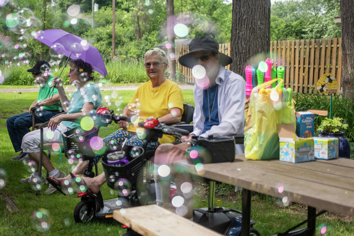 Community members join residents of Washington Woods senior housing for a Fairy Garden celebration Thursday, June 30, 2022 in Midland.