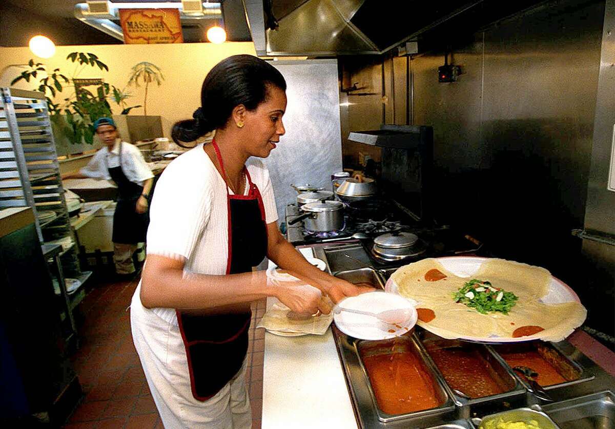 Mehret Tesfalidet prepares a plate at Massawa in the Haight. The restaurant moved on to North Beach and shut down in June.