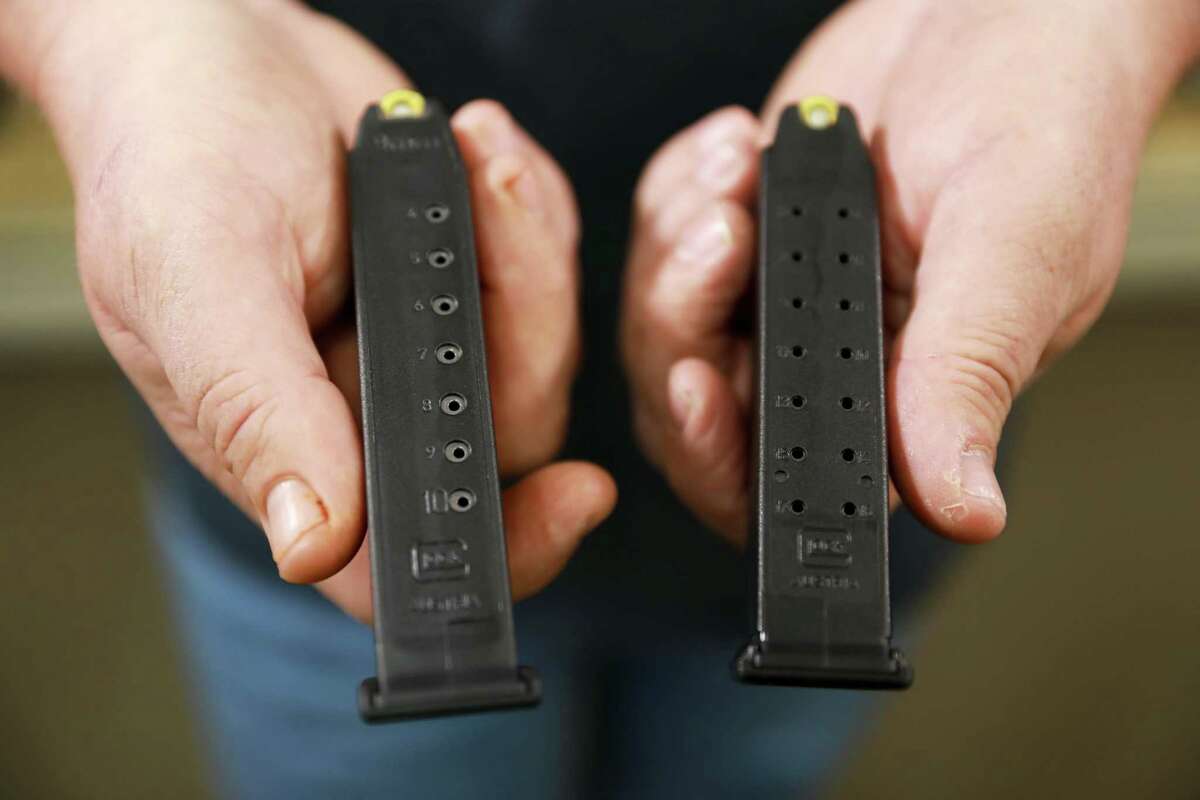 Gun store owner John Parkin holds two magazines inside Coyote Point Armory in Burlingame, Calif., on April 10, 2019. The magazine on the left has 10 rounds and the magazine to the right has 17 rounds.