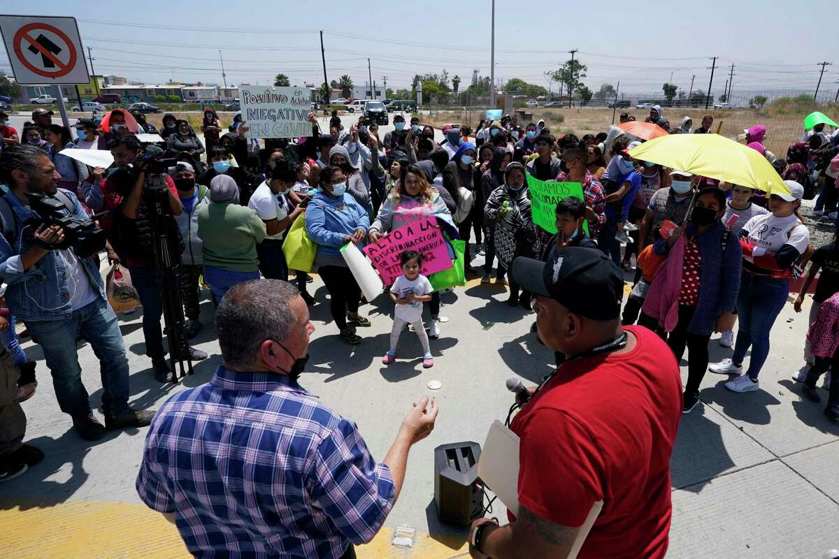 FILE - People gather as Rev. Albert Rivera, bottom left, speaks during a protest of people waiting in Mexico as they hope to apply for asylum, May 19, 2022, in Tijuana, Mexico. The Supreme Court has ruled that the Biden administration properly ended a Trump-era policy forcing some U.S. asylum-seekers to wait in Mexico. The justices’ 5-4 decision for the administration came in a case about the “Remain in Mexico” policy under President Donald Trump. (AP Photo/Gregory Bull, File)