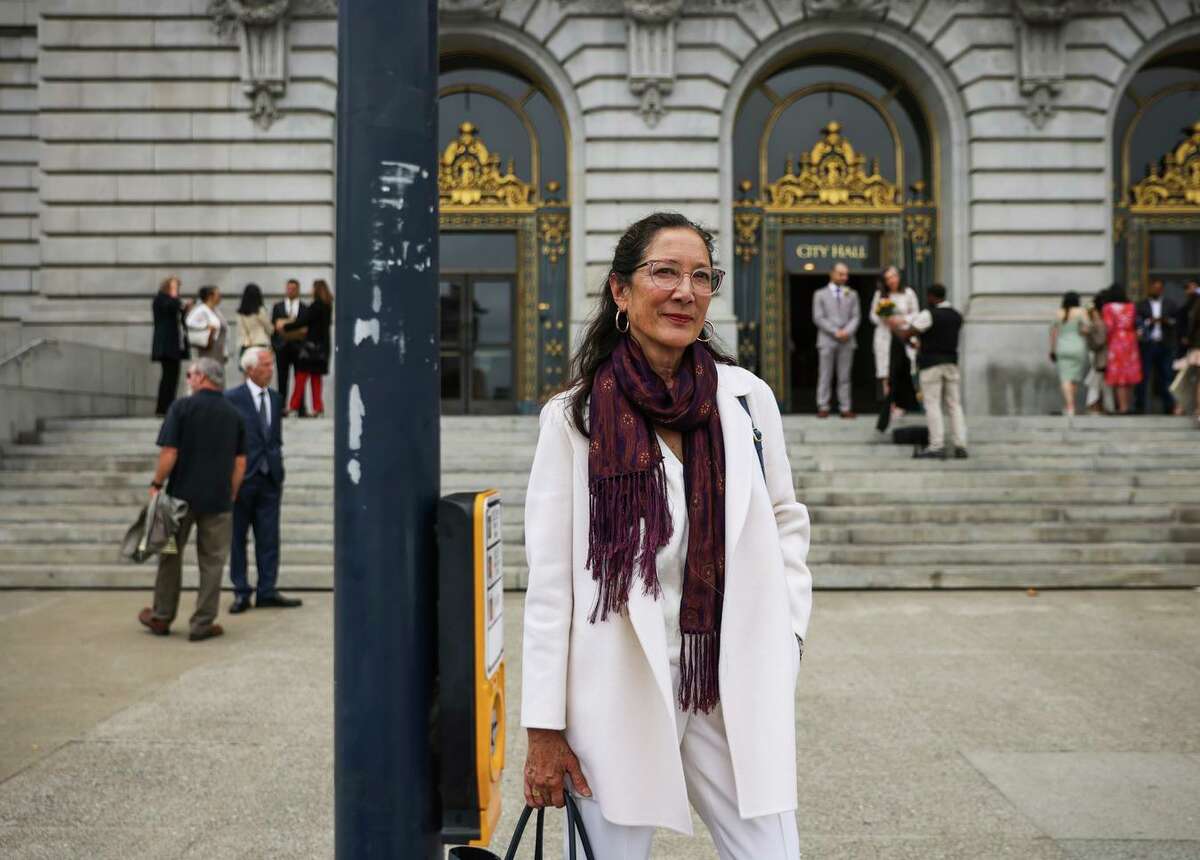 Rebecca Young waits to cross the street after filing paperwork to campaign for public defender at City Hall in San Francisco, Calif., on Thursday, June 30, 2022.