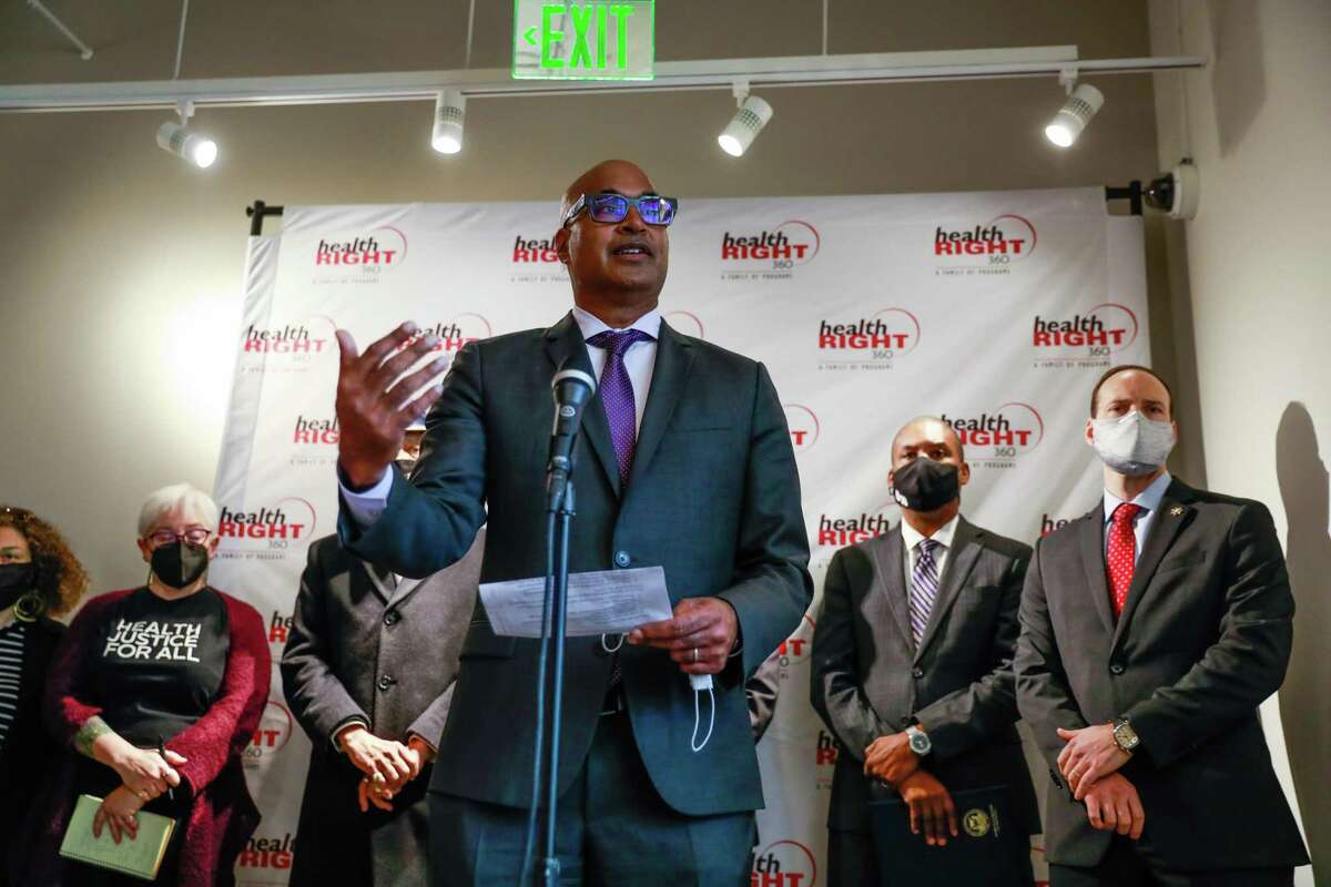 FILE-San Francisco Public Defender Mano Raju (center) speaks during a press conference in protest of Mayor London Breed’s plan for more policing and enforcement of laws that could affect drug users in the Tenderloin neighborhood on Monday, Dec. 20, 2021 in San Francisco, California.
