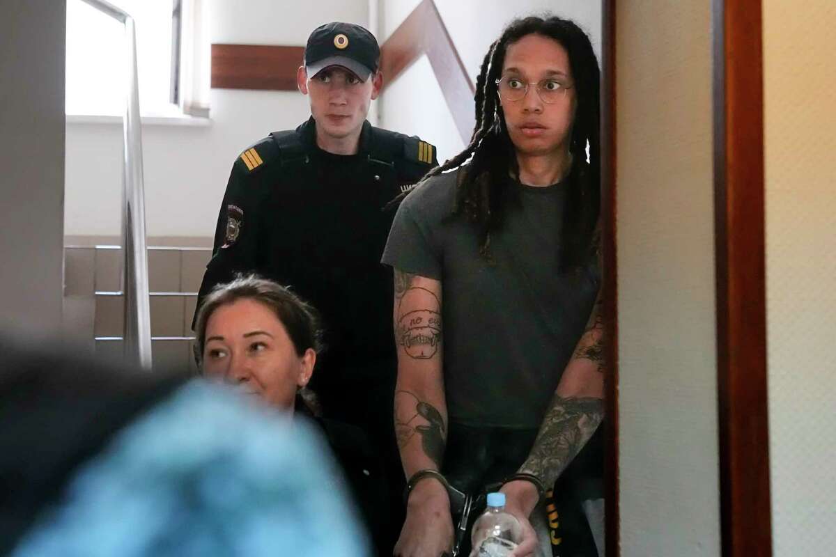 WNBA star and two-time Olympic gold medalist Brittney Griner is escorted to a courtroom for a hearing, in Khimki just outside Moscow, Russia, Monday, June 27, 2022. The proceedings that began Friday come about 4 1/2 months after she was arrested on cannabis possession charges at an airport while traveling to play for a Russian team.