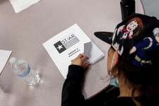 A fourth grader flips open her STAAR mathematics booklet to go over her answers during class at Heritage Elementary School in San Antonio, Texas, on March 3, 2022. Superintendent Ramirez visited the school as part of his ongoing teacher assessments and mock testing evaluations.