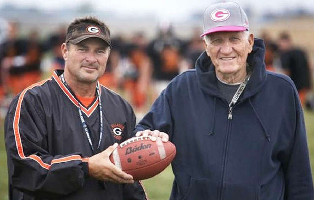 Gillespie coach Don Dobrino (right) and Don Borgini pose with a ball that first began their bond in 1973 when Borgini was a freshman quarterback and Dobrino was the Miners football coach. Dobrino died Sunday, July 4, 2021, at 86.