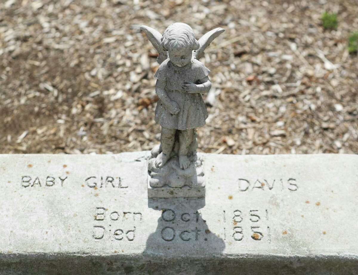 One of two children grave markers from the mid 1800s is seen outside the N.H. Davis Pioneer Complex & Museum, Thursday, June 30, 2022, in Montgomery. The Montgomery Economic Development Council recently purchased the land adjacent to the property near Texas 105 and Liberty Street and plan to use ground-penetrating radar to officially locate the two graves. The city doesn’t have any further development plans for the property.