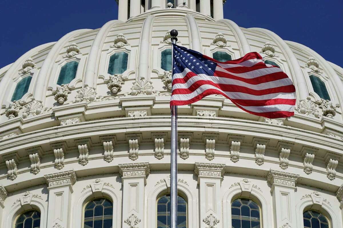An American flag waves outside the U.S. Capitol. This July Fourth, arrives with many Americans feeling that their voices are being ignored or targeted for silence, and that the democracy they cherish is under attack.