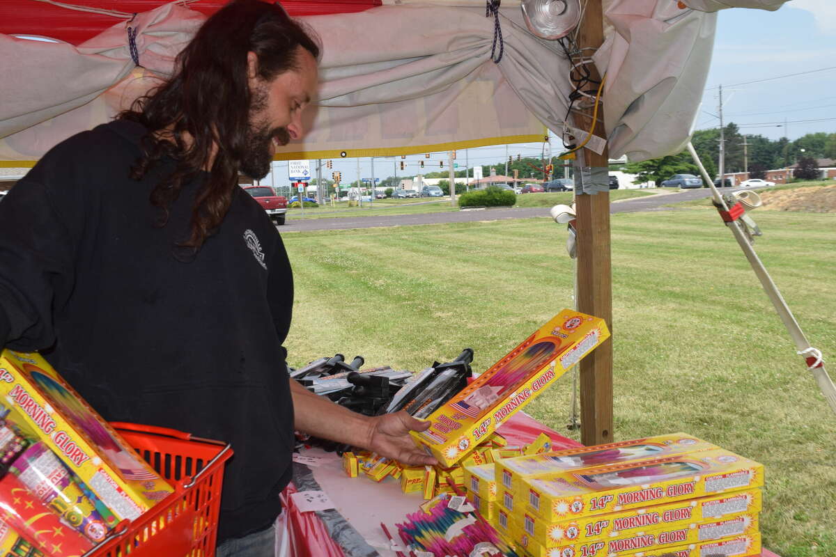 Sean Anderson of Chapin examines a pack of Morning Glory sparklers before buying them at a fireworks stand at 1813 W. Morton Ave. The stand will be selling fireworks from 10 a.m. to 10 p.m. through Monday.