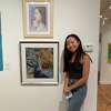 Ava Lee, 17, stands by her art at the Ridgefield Guild of Artists September 10, 2021. Her latest exhibit, on display at the Greenwich Arts Society, shows pieces of her journey with scoliosis.