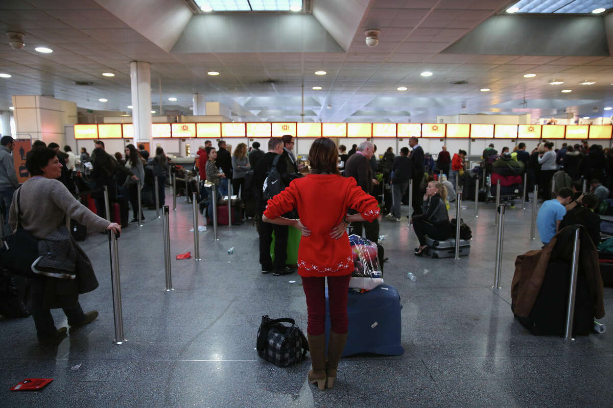 Passengers wait in the departure hall of Gatwick Airport's North Terminal.