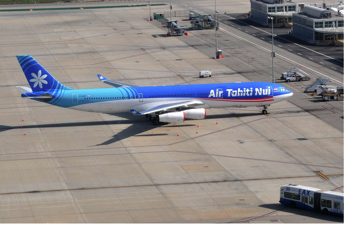 An Air Tahiti Nui Airbus A340 aircraft parked on a service ramp or apron away from the passenger gates at LAX.