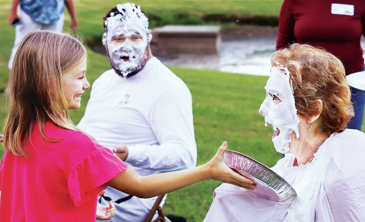 John Badman|The Telegraph Hailey Krohn, 8, enjoyed shoving a pie into the face of Ann McLaughlin, Director of Children's Ministries at Godfrey 1st United Methodist Church in Godfrey Thursday evening as part of a reward to end a five church Vacation Bible School. Teacher Jake Brey, background, was also a pie recipient. The school was held at the church, 1100 Airport Road, with about 46 children participating. They played various games and did arts and crafts with the theme being the Southwest. The church raised $192.58 to fund school supplies for Native American students.