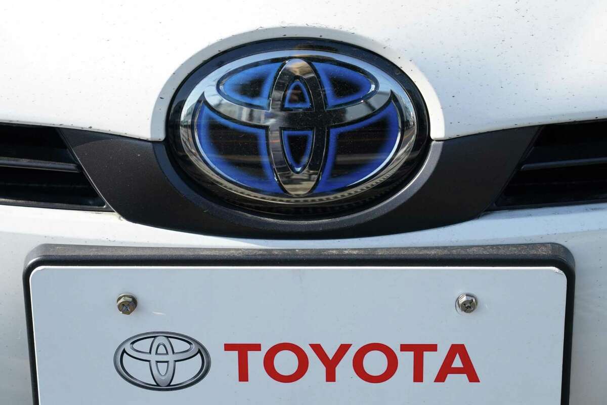 The Toyota badge is seen on a Prius hybrid vehicle at the company's dealership in Tokyo on Jan. 28, 2022. MUST CREDIT: Bloomberg photo by Toru Hanai