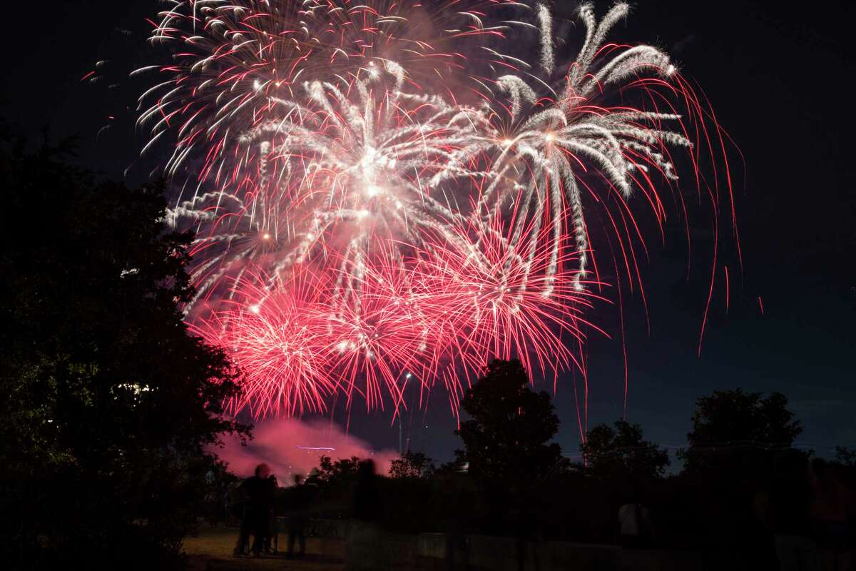 The 2021 Shell Freedom Over Texas fireworks show goes off on Buffalo Bayou Sunday, July 4, 2021, from Eleanor Tinsley Park in Houston. While the concert is still virtual this year, people were allowed to be at the park to watch the fireworks.
