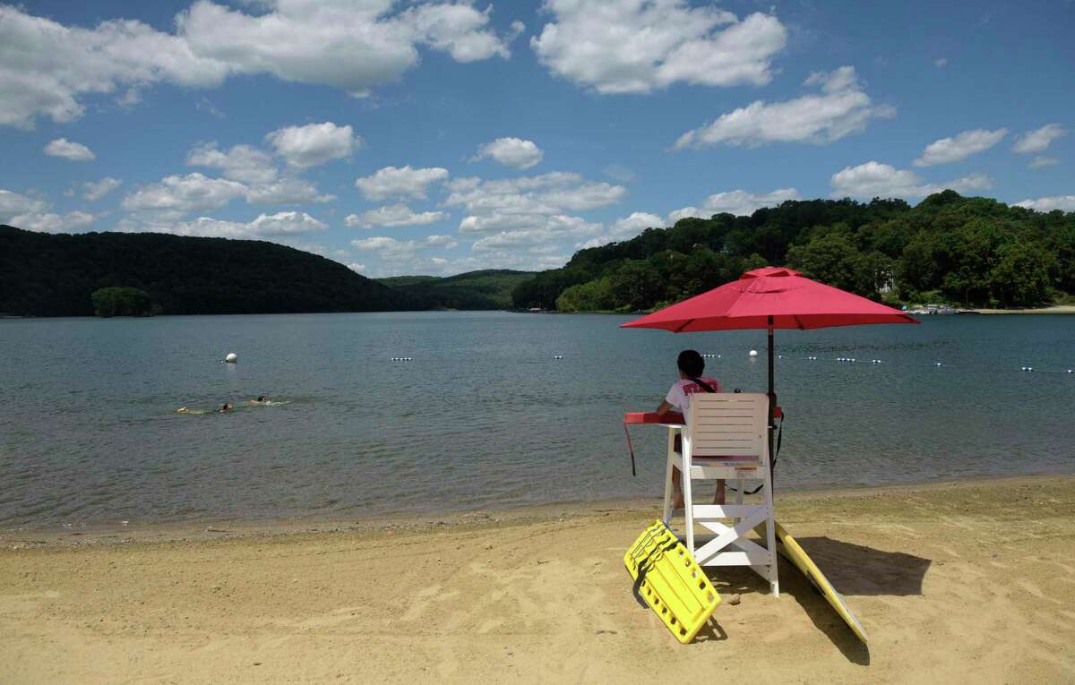 Lifeguard Ian Chen keeps an eye on swimmers at Candlewood Town Park on Wednesday, June 29, 2022, Danbury, Conn.