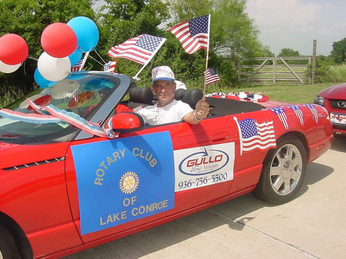 Former Rotarian Mark Stephens driving the Gullo red convertible in a previous Fourth of July Parade.