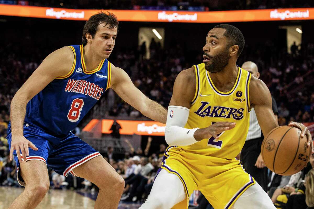 Golden State Warriors forward Nemanja Bjelica defends as Los Angeles Lakers guard Wayne Ellington looks to make a pass during the fourth quarter of their NBA basketball game in San Francisco, Calif. Thursday, April 7, 2022.