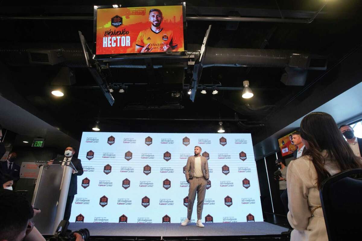 Houston Dynamo midfielder Héctor Herrera stands on the stage during an introductory news conference Friday, July 1, 2022 in Houston. Herrera, the highest-profile international signing in Dynamo history, is a captain with the Mexican national team and comes to Houston from Atlético de Madrid in Spain.