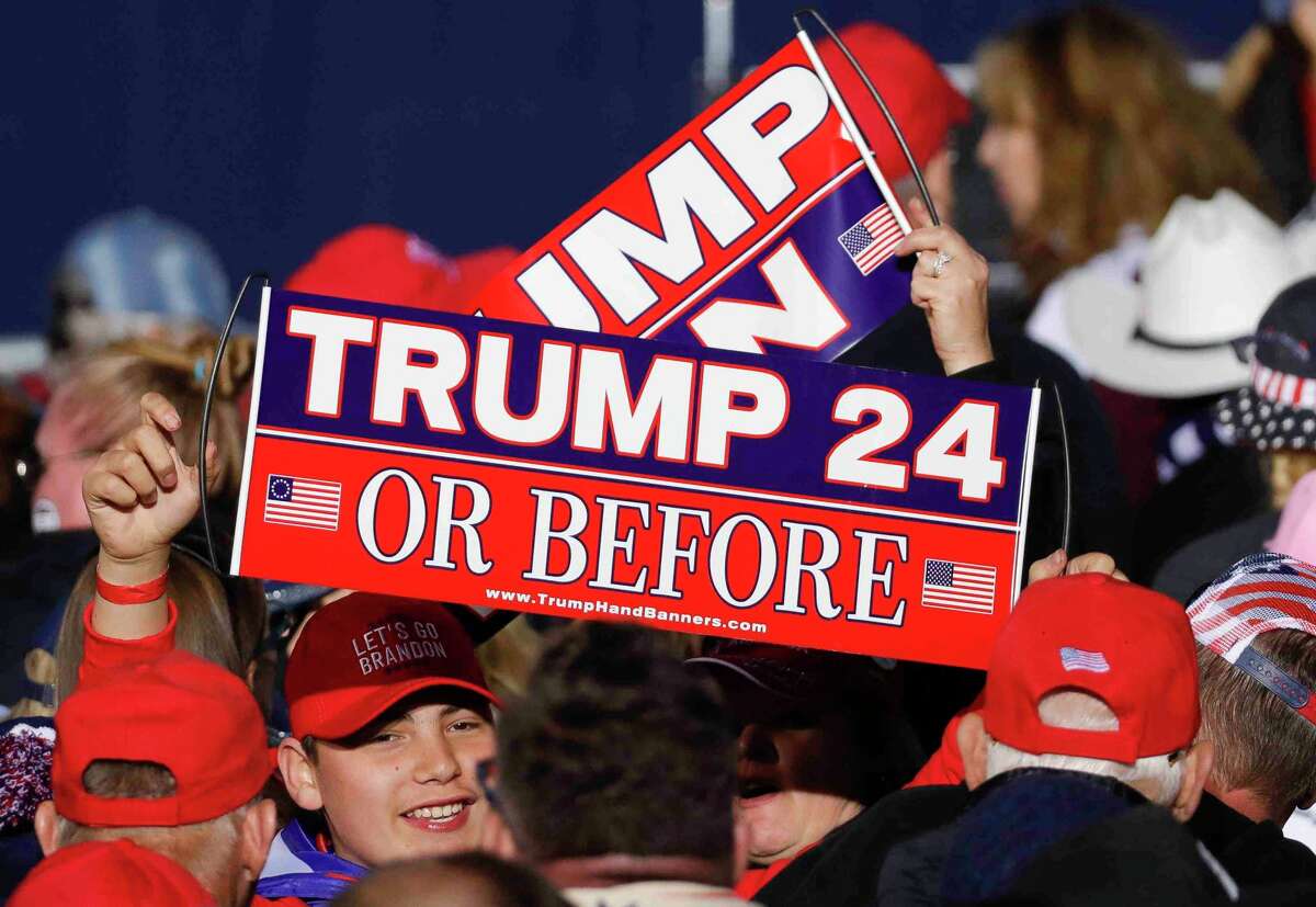 A Trump fan holds up a sign before former President Donald Trump speaks at a Save America Rally, Saturday, Jan. 29, 2022, in Conroe.