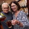 Philip Parda, left, pours his wife, Judith, a cup of tea at at the new location of their store, Savvy Tea Gourmet, at 712 Boston Post Road in Madison on June 23, 2022.