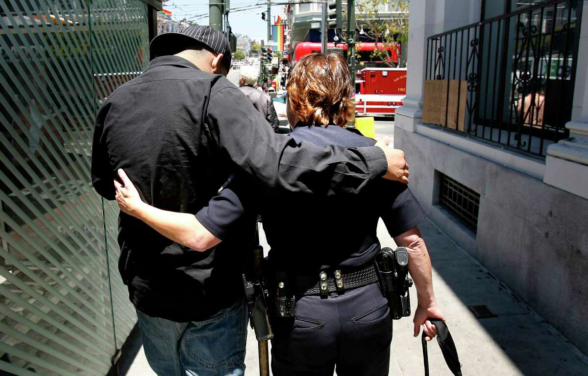 In a 2007 photo, a San Francisco police officer gets a hug from a friend on the beat.