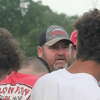 Reed City coach Scott Shankel (center) talks with his players after Thursday's passing camp.