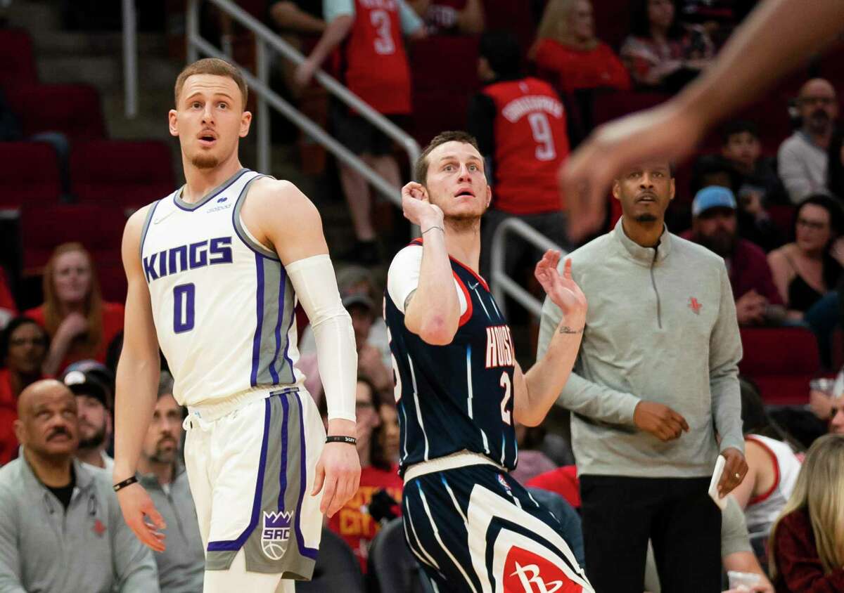 Sacramento Kings guard Donte DiVincenzo (0) watches as a three point shot by Houston Rockets guard Garrison Mathews (25) heads towards the hoop during the first half of a NBA game between the Houston Rockets and Sacramento Kings on Friday, April 1, 2022, at Toyota Center in Houston.