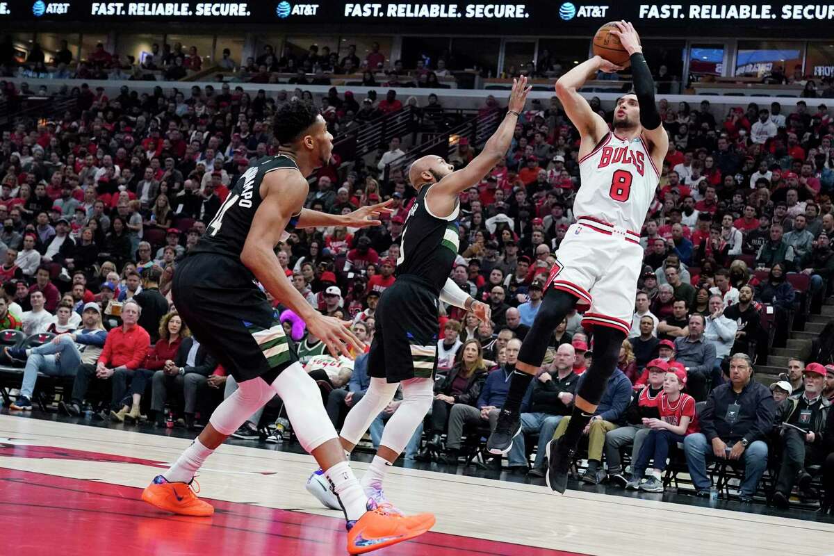 Chicago Bulls guard Zach LaVine shoots against Milwaukee Bucks guard Jevon Carter and forward Giannis Antetokounmpo in a first-round NBA playoff game on April 22 in Chicago.