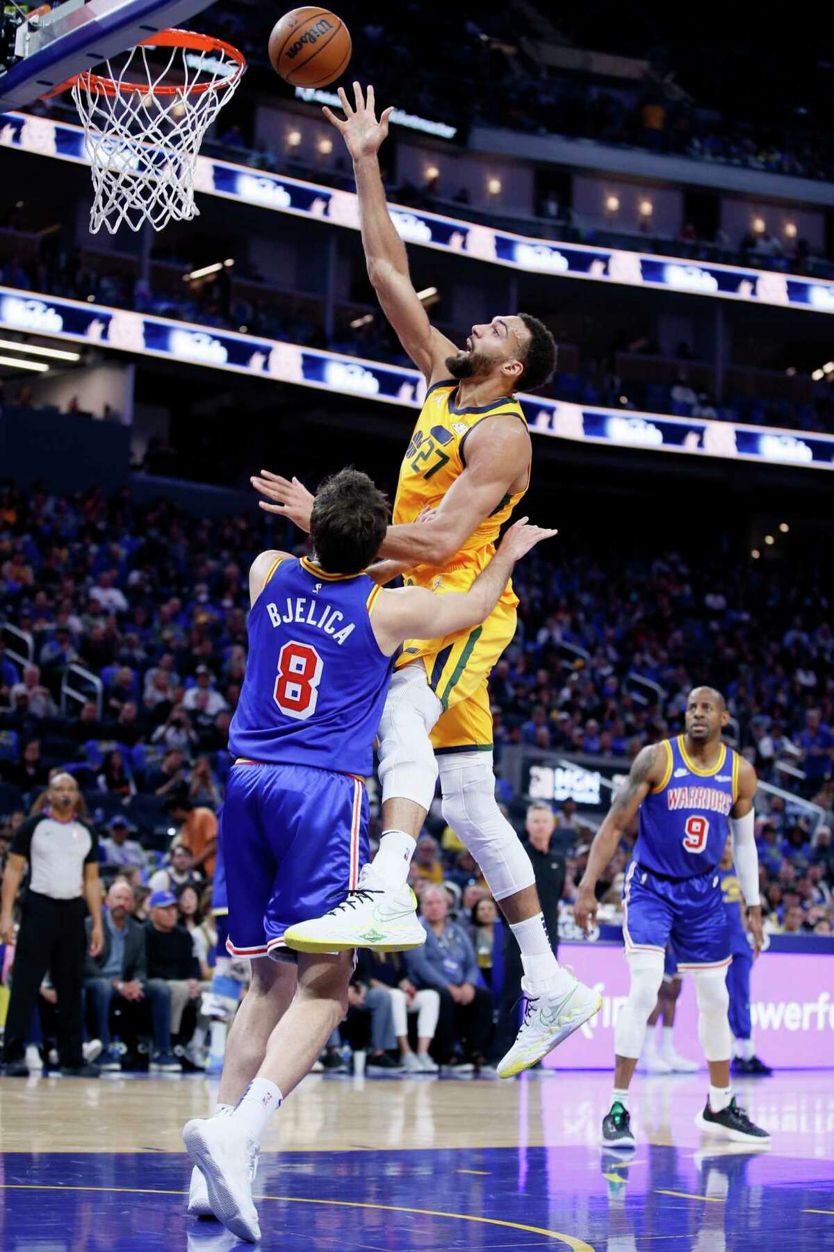 Utah Jazz center Rudy Gobert (27) scores against Golden State Warriors forward Nemanja Bjelica (8) in the first half of an NBA game at Chase Center, Saturday, April 2, 2022, in San Francisco, Calif.
